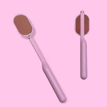 Load image into Gallery viewer, a pink and white toothbrush sitting on a pink surface 
